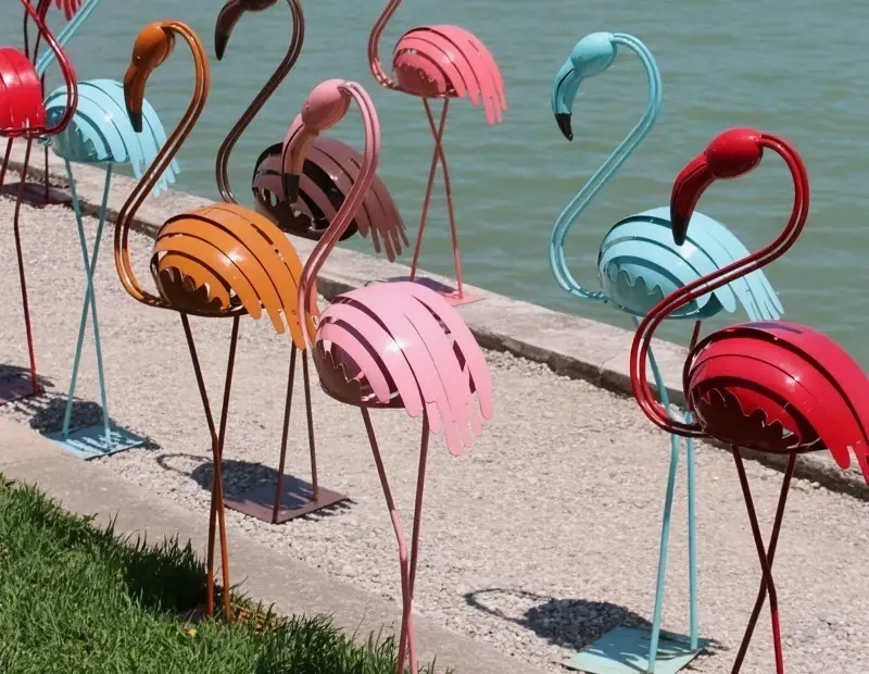 Garden Craft Idea: Colorful Metal Flamingo Sculptures by the Water